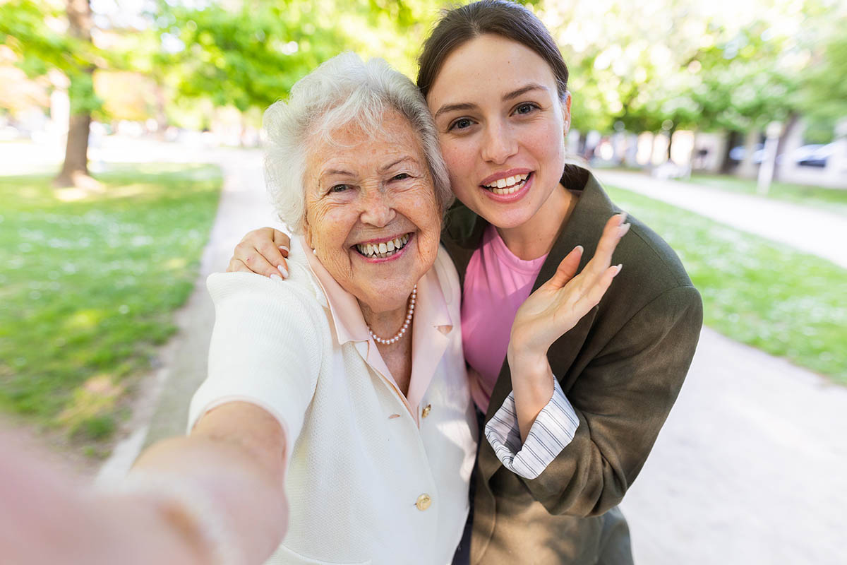 Older woman and younger woman smiling together