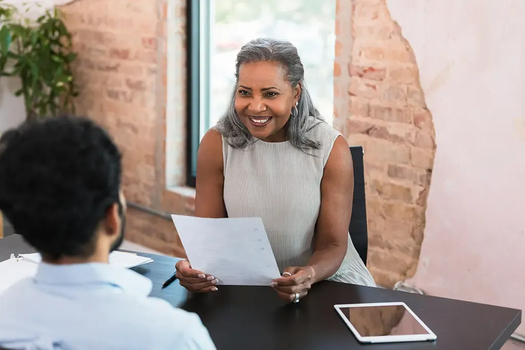 Mature woman talking with a younger man