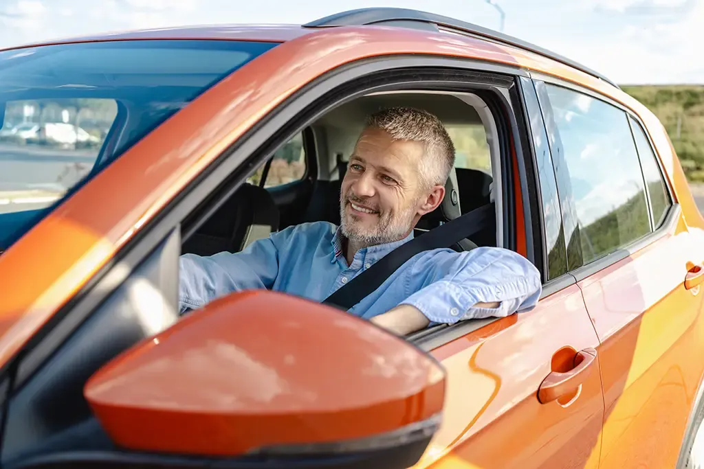 Mature man driving a car