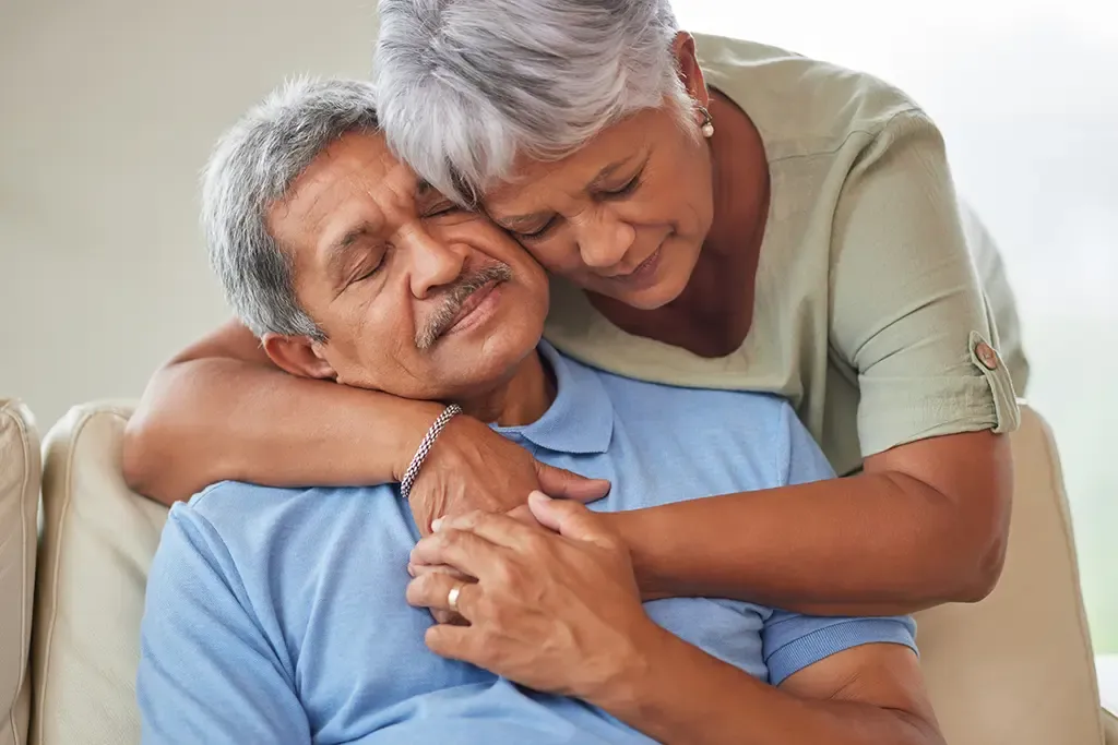 Older woman hugging her husband