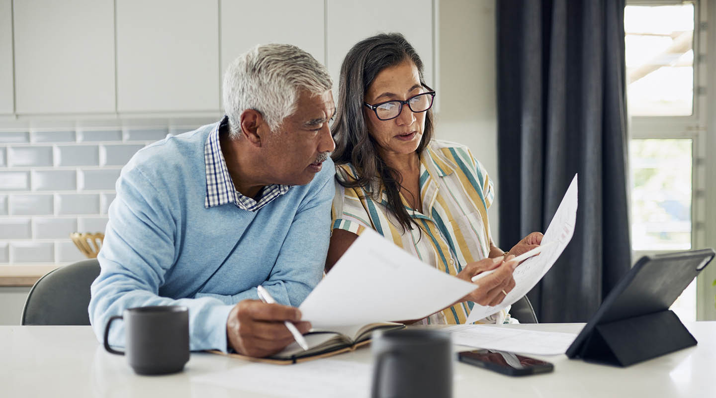 Mature couple reviewing bills